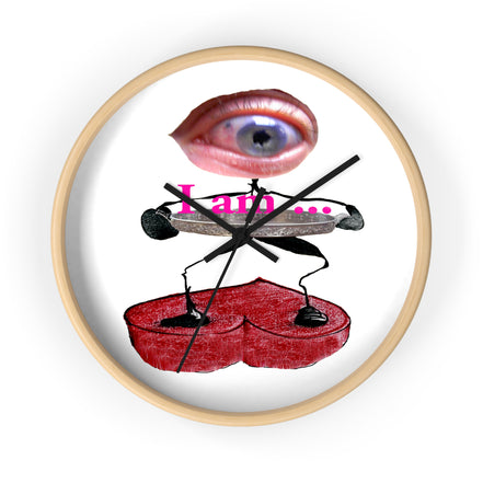 Front view of I Am designer wall clock with eye artwork, red and pink tones, black graphic elements, and white clock face.