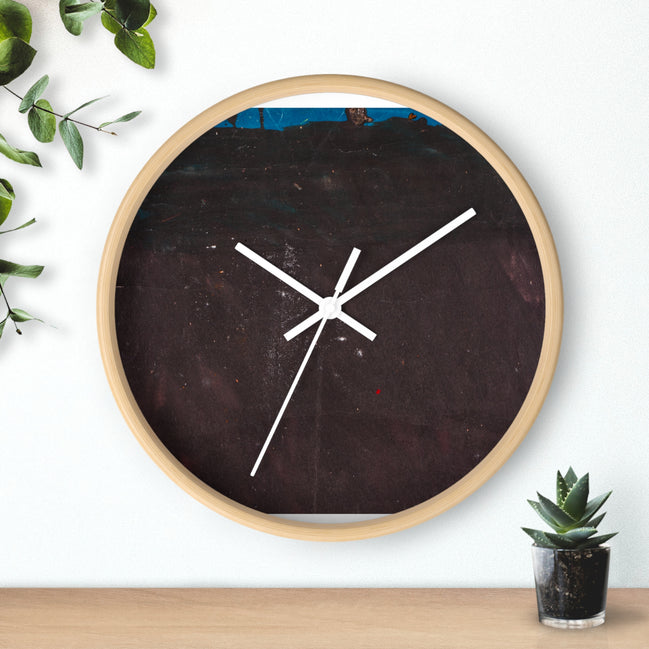 Round designer wall clock with a light wood frame featuring a dark brown to charcoal abstract valley-style texture with white clock hands, mounted on a wall.