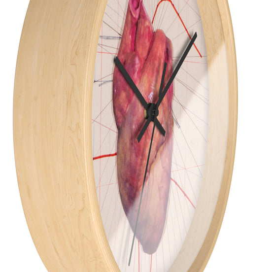 Side view of anatomical heart wall clock showing light natural wood frame depth and black clock hands.