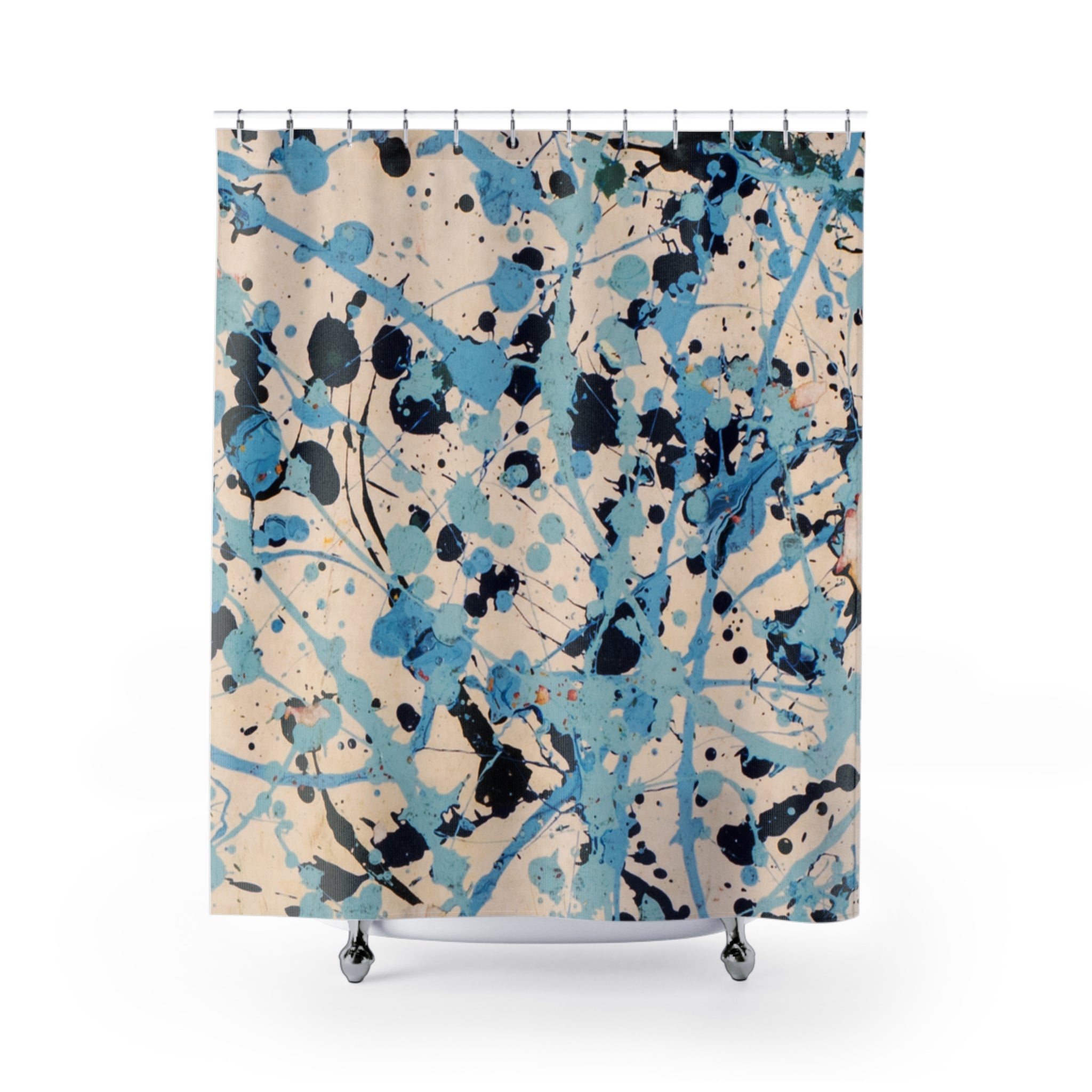 Abstract coastal shower curtain with blue splatter artwork on a beige background