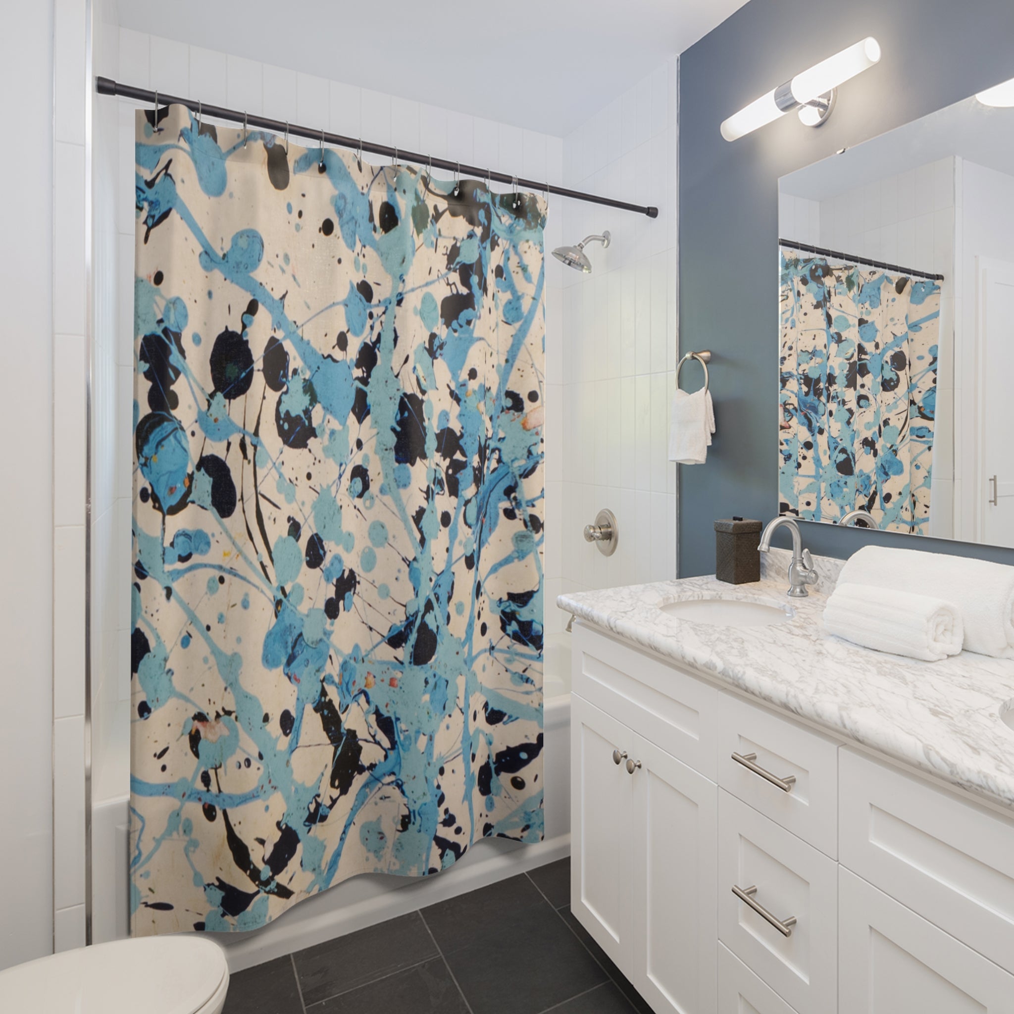 Modern bathroom styled with an abstract blue coastal splatter shower curtain as statement decor
