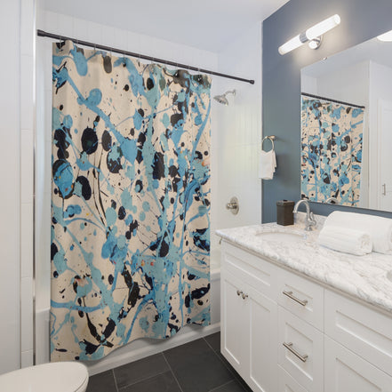 Modern bathroom styled with an abstract blue coastal splatter shower curtain as statement decor
