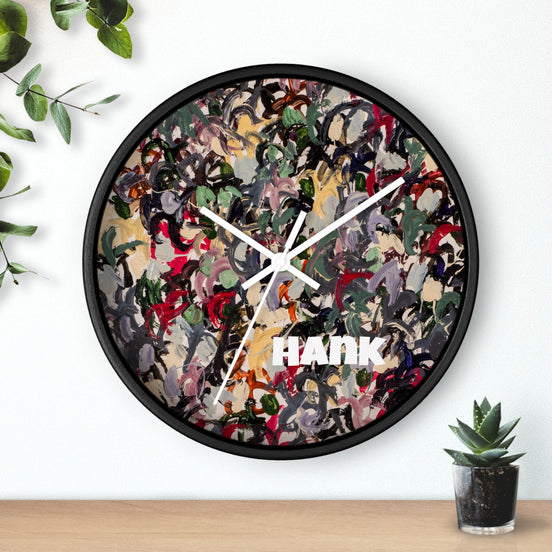 Front view of HANK abstract expressionist wall clock featuring dense multicolor painted artwork, white clock hands, and a black base.