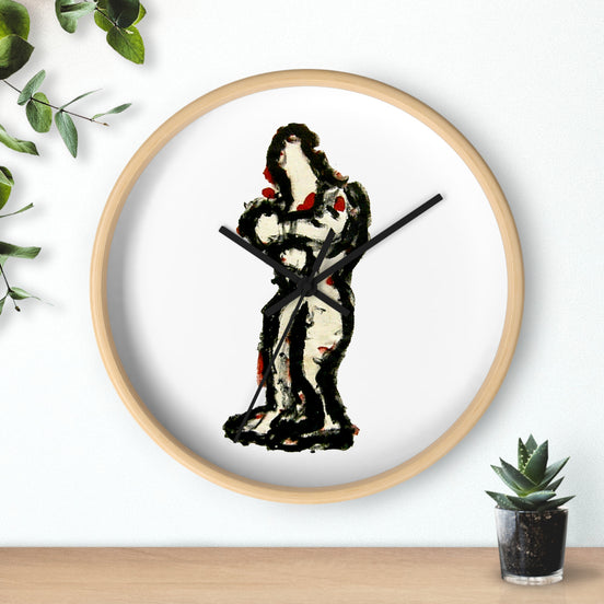 Abstract art wall clock with hand-painted In-Tense black and red standing figure on a white clock face in a light wood frame, sitting on a shelf beside a small plant.