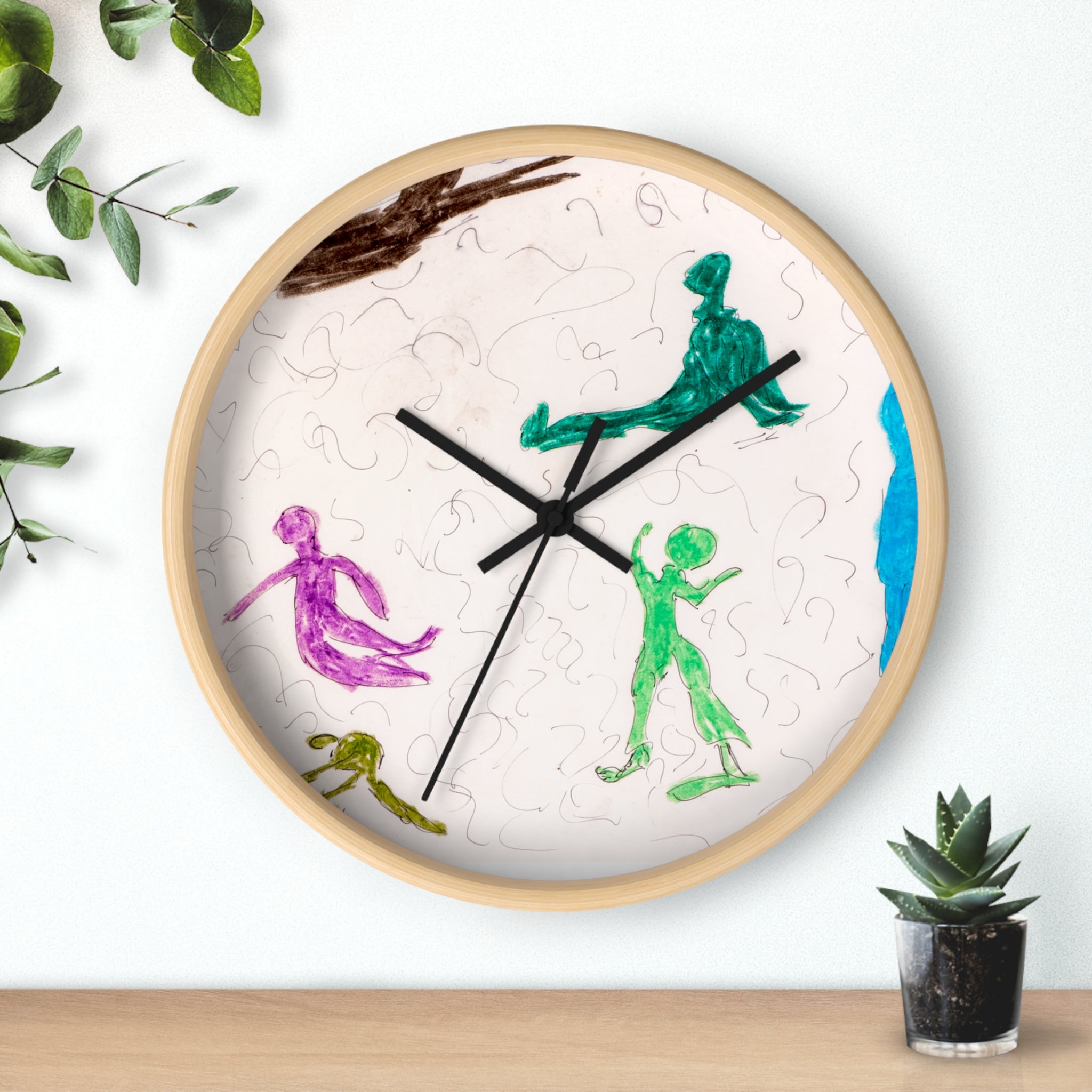 Playground abstract figures wall clock with playful hand-drawn line art in green and purple on a light face, black hands, and a natural wood frame, styled as modern wall decor.