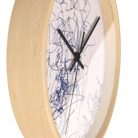 Side view of Time Spent designer wall clock showing natural wood frame depth, black hands, and blue line art on a light neutral face.